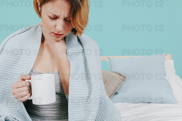 Woman with cup feeling sick