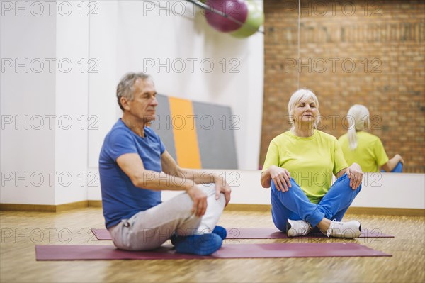 Retired couple doing yoga