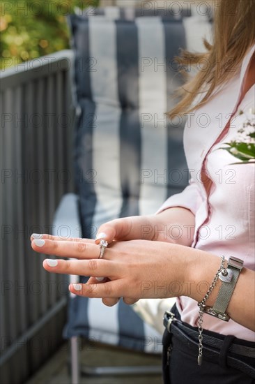 Hand of a young woman with a nice ring. Engagement. The scene on the balcony. Vertical image