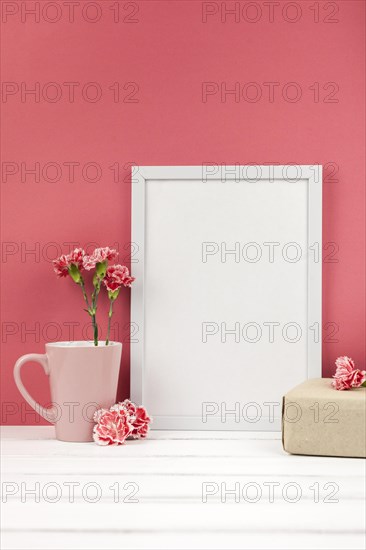 Carnation flowers gift box cup white empty frame table
