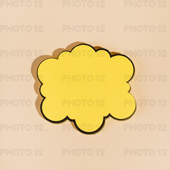 Empty yellow speech bubble beige background