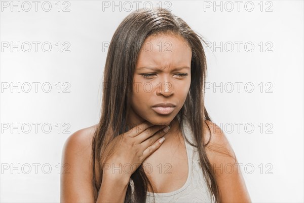 Portrait sick teenage girl with sore throat