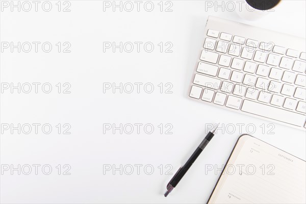Pen notebook near keyboard