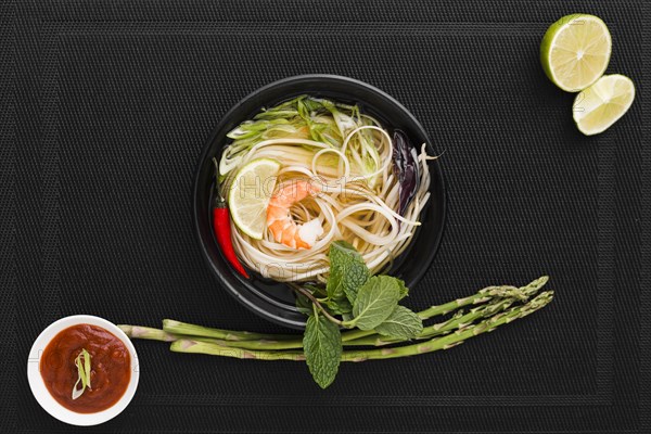 Top view noodles bowl with asparagus