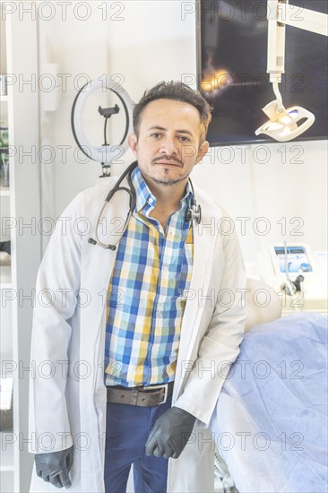 Latino doctor posing in his beauty center