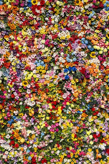 Artificial flowers on a house wall in Lisbon