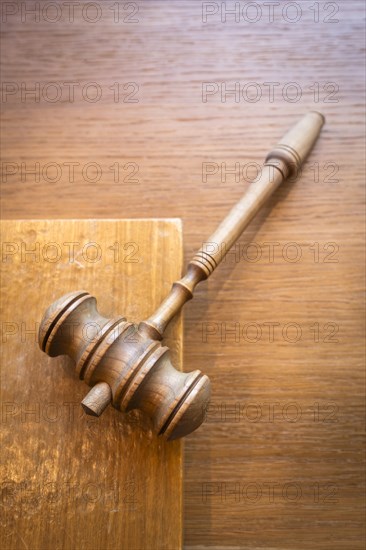 Wooden hammer of a chairman or judge on a wooden table