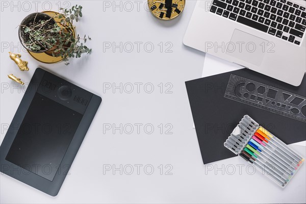 Digital graphic tablet laptop mock up with office objects white background