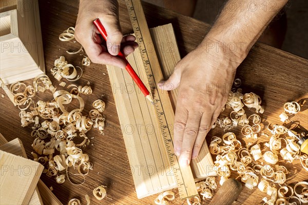 Carpenter measuring with ruler pencil