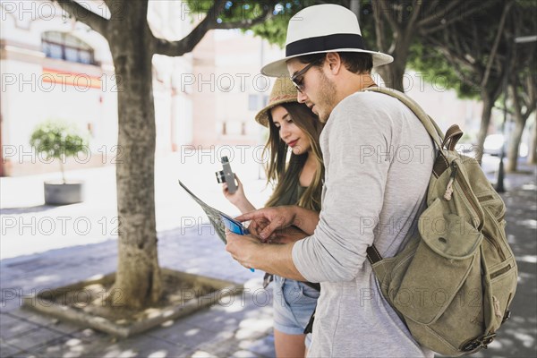 Couple tourists looking map