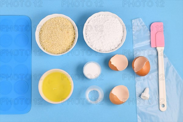 Ingredients for making homemade French Macarons sweets including powdered sugar