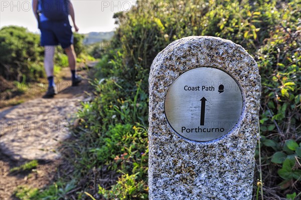 Walkers next to waymarker