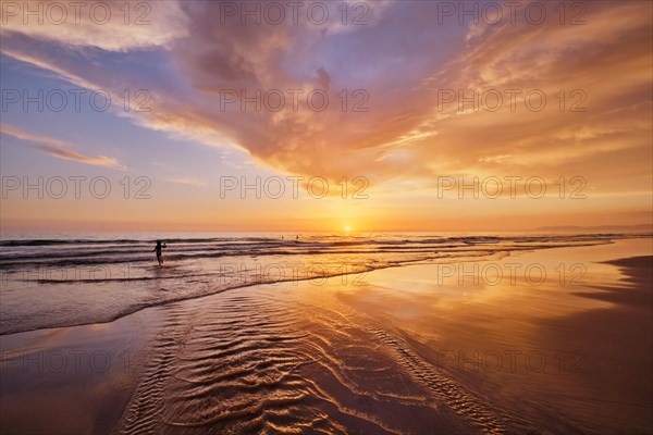 Atlantic ocean sunset with surging waves at Fonte da Telha beach