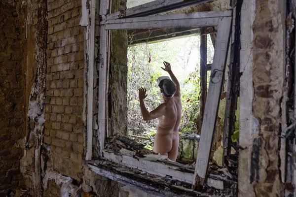 Man dressed in suit wearing VR glasses in a dilapidated office building