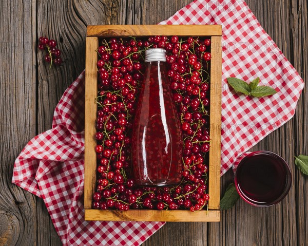 Cranberry juice bottle wooden background