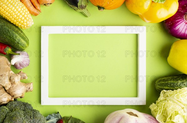 Top view empty frame with arrangement vegetables