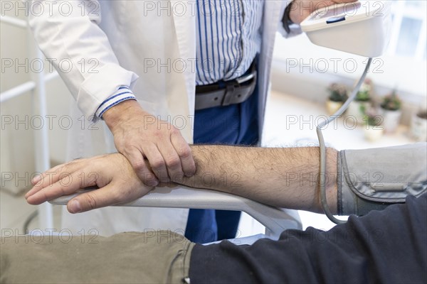 Doctor taking patient's blood pressure