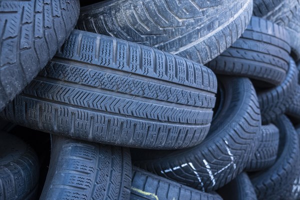 Pile of worn old tyres from passenger cars