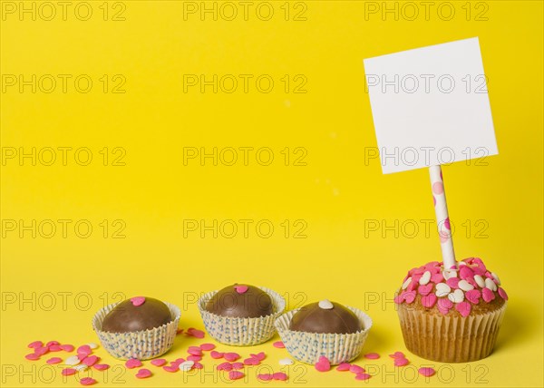 Delicious sweet candies cake with paper stick