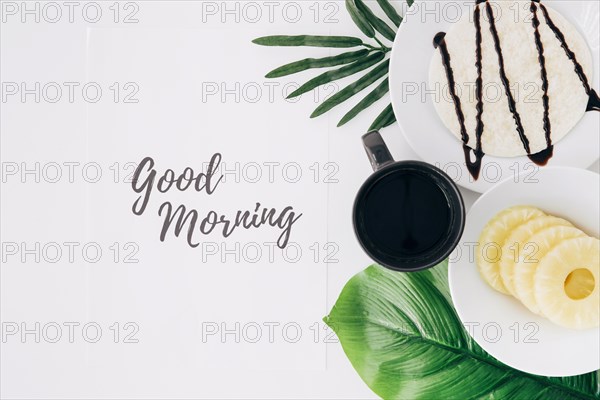 Pineapple slices tortillas coffee leaves with good morning text paper white background