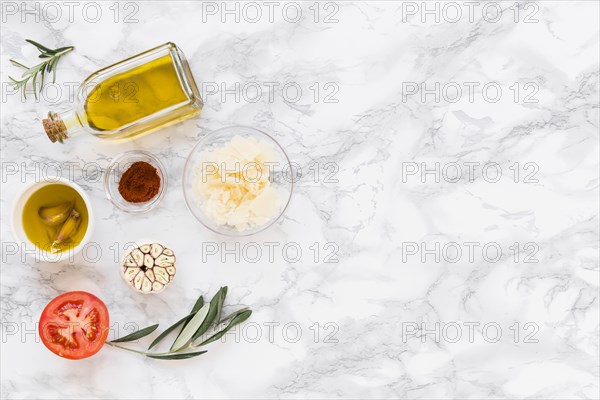 Various ingredients with oil white marble background