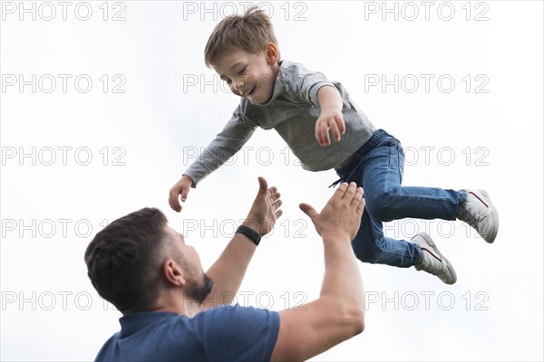 Father son playing low view
