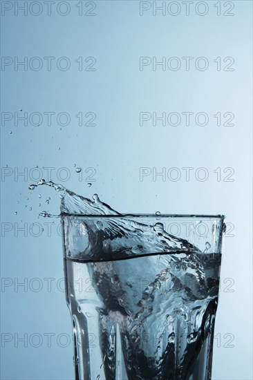 Clear glass with water splashing