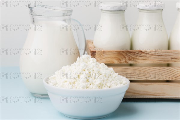 Close up milk jug with fresh cottage cheese