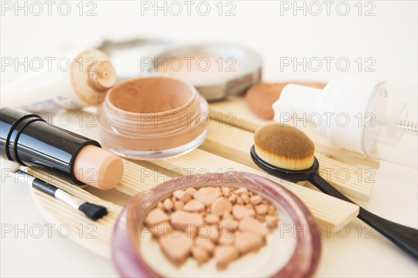 Close up woman s cosmetics used makeup powder brush lipstick cream