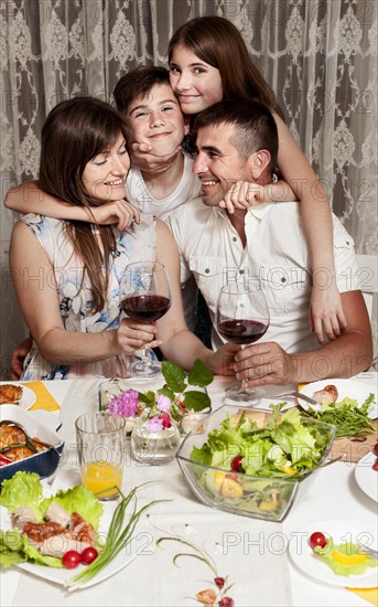 Front view happy family dinner table