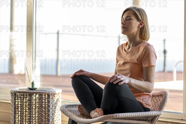 Full shot woman chair meditating