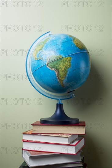 Stacked books with globe