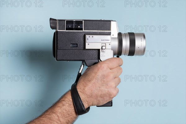 Close up man s hand holding against blue background