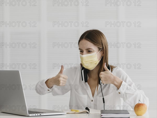 Teacher attending her online course wearing medical mask