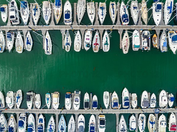 Top Down view over Boats and Yachts in Brixham Marina from a drone
