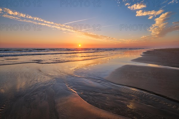 Atlantic ocean sunset with surging waves at Fonte da Telha beach