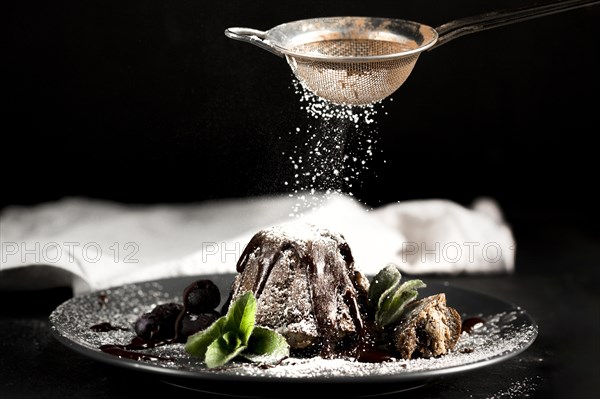 Front view chocolate cake with powdered sugar