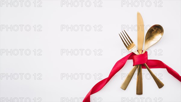 Spoon knife fork with red ribbon