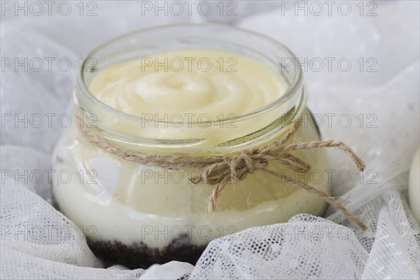 Rope tied around lemon curd jar white lace fabric