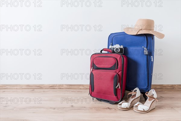 Peep toe shoes hat near suitcases camera