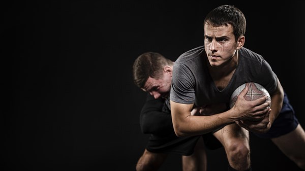 Front view male rugby players with ball copy space