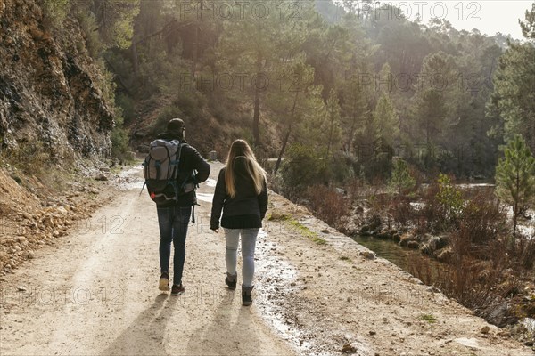 Couple with backpack exploring nature 1