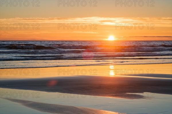 Atlantic ocean sunset with surging waves at Fonte da Telha beach