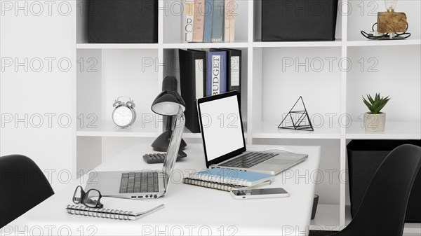 Office desk surface with two laptops