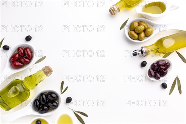 Red black yellow purple olives spoons with oil bottle