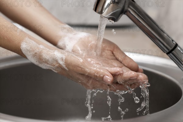 Person washing hands sink