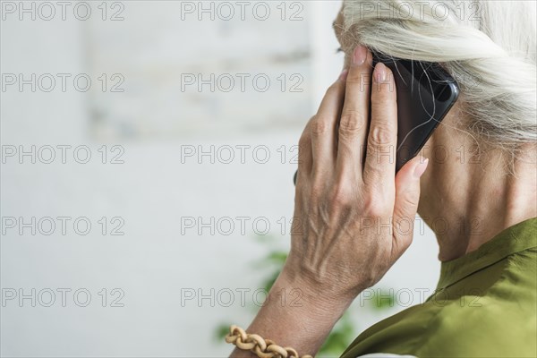 Senior woman s hand using cellphone