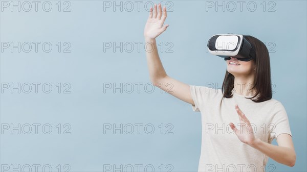 Front view woman experiencing virtual reality
