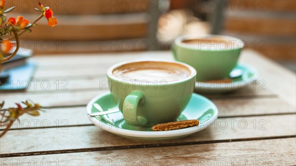 Two coffee cup wooden table