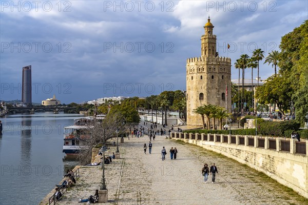 Waterfront on the Guadalquivir River with the historic Torre del Oro tower in Seville